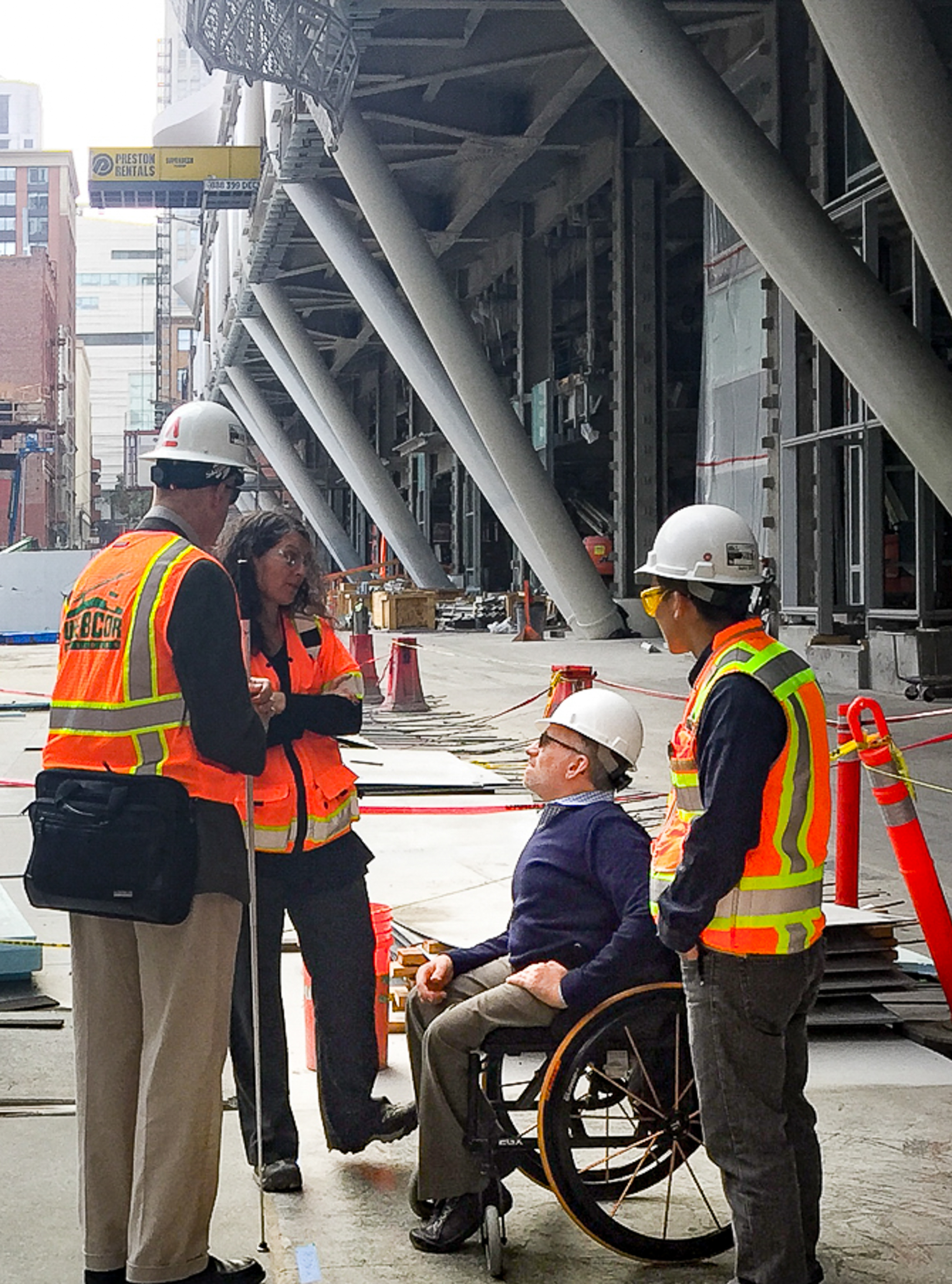 Erick in his wheelchair consulting with the construction team at the Transbay Terminal